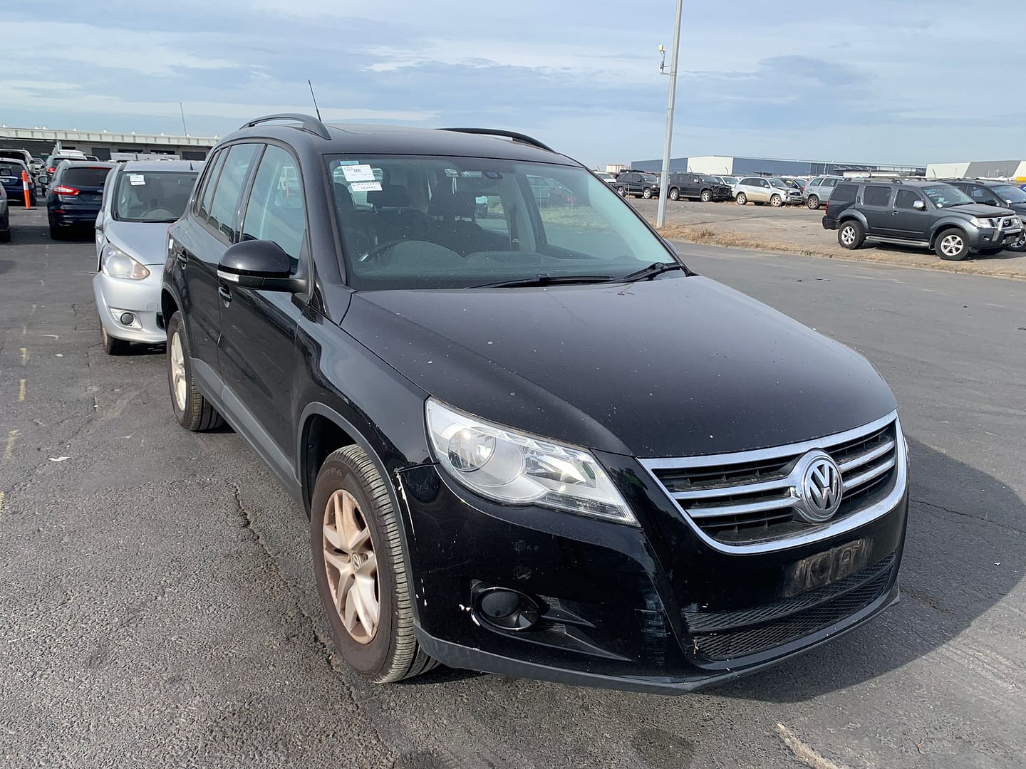 Black SUV in a vehicle yard