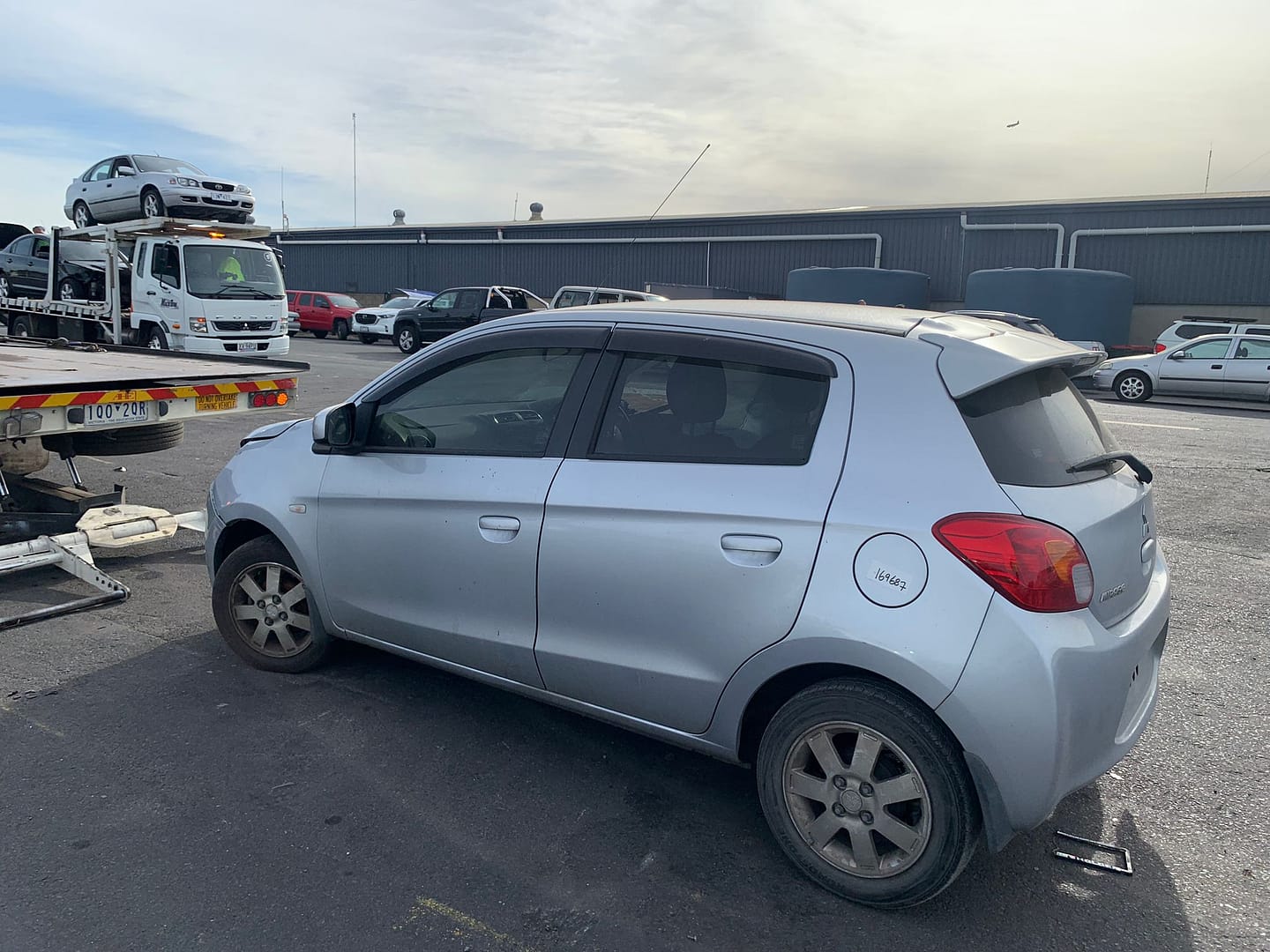 Silver hatchback in a vehicle yard