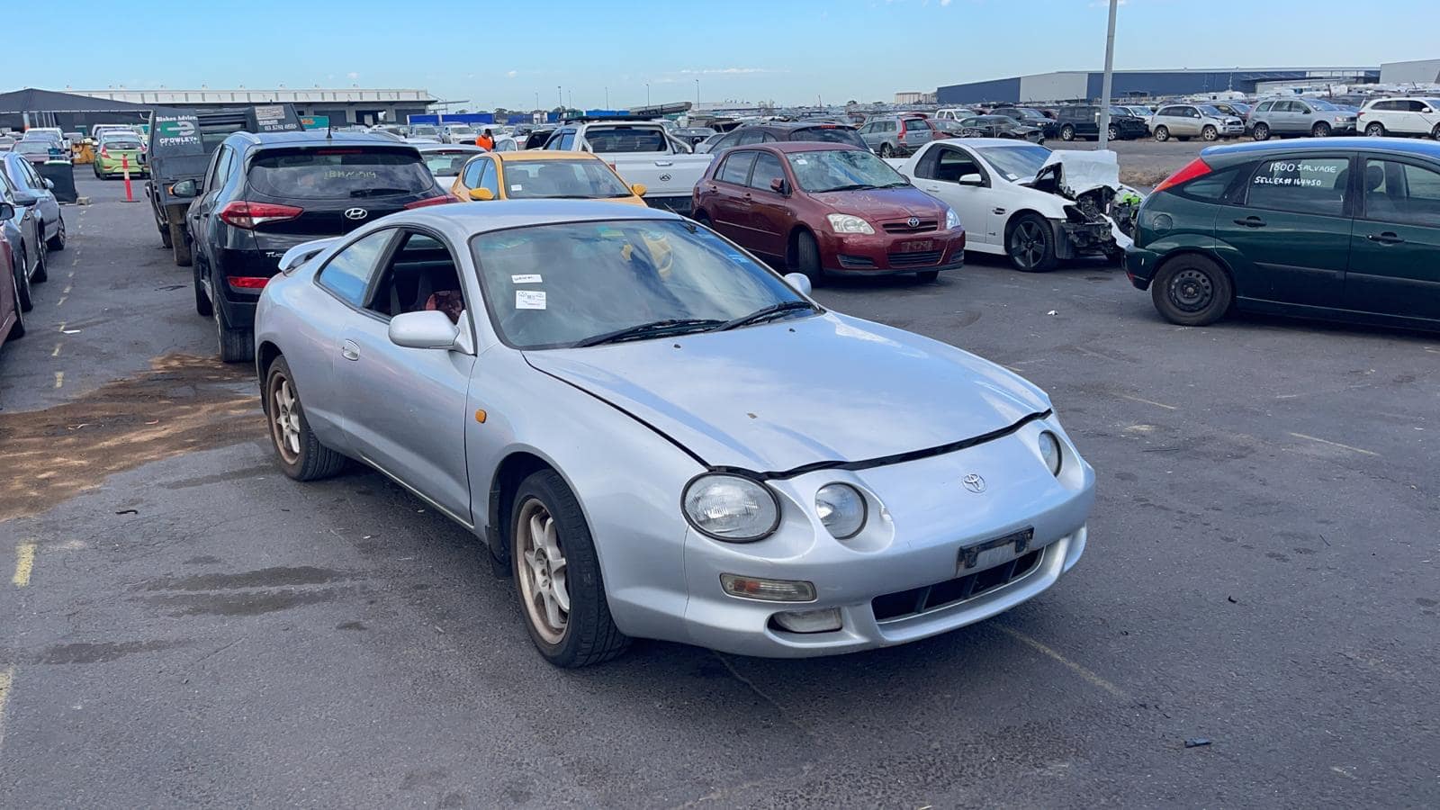 Silver coupe in a vehicle yard