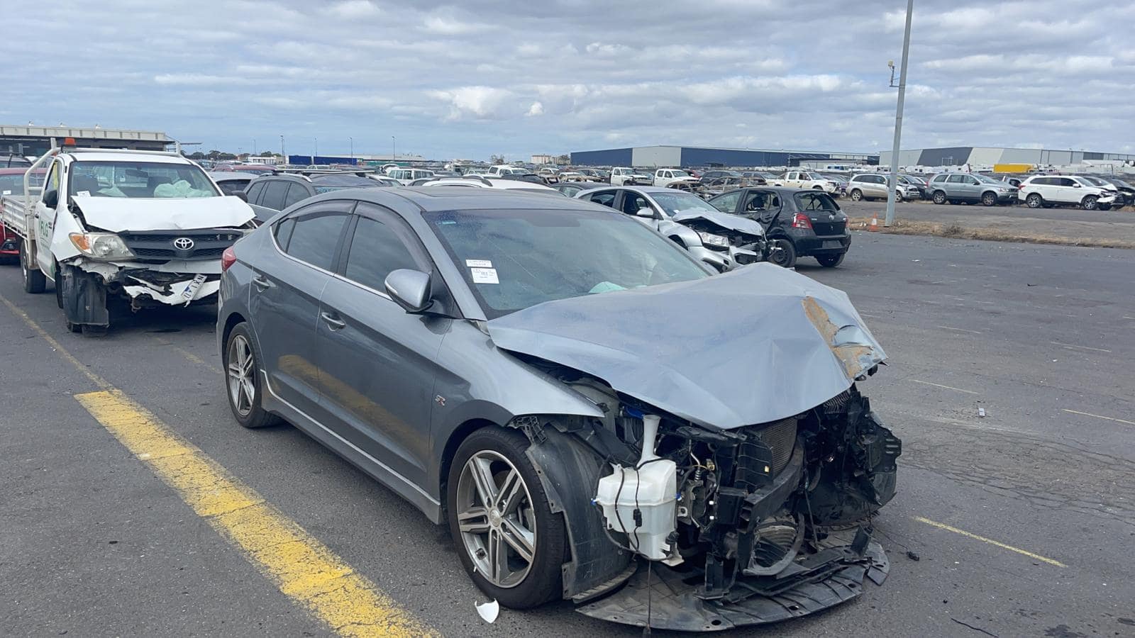 Silver sedan with accident damage