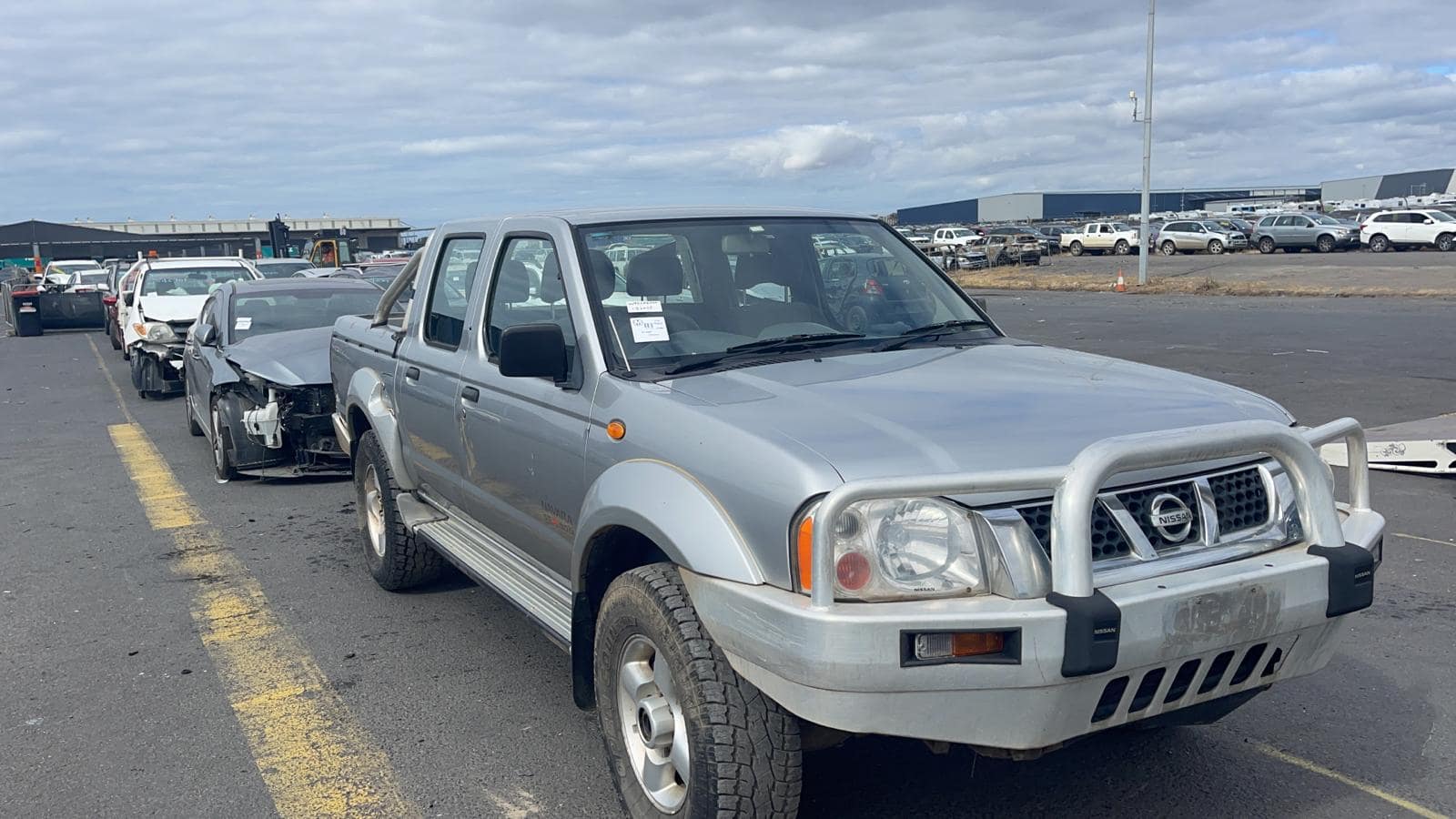 Silver utility vehicle in a vehicle yard