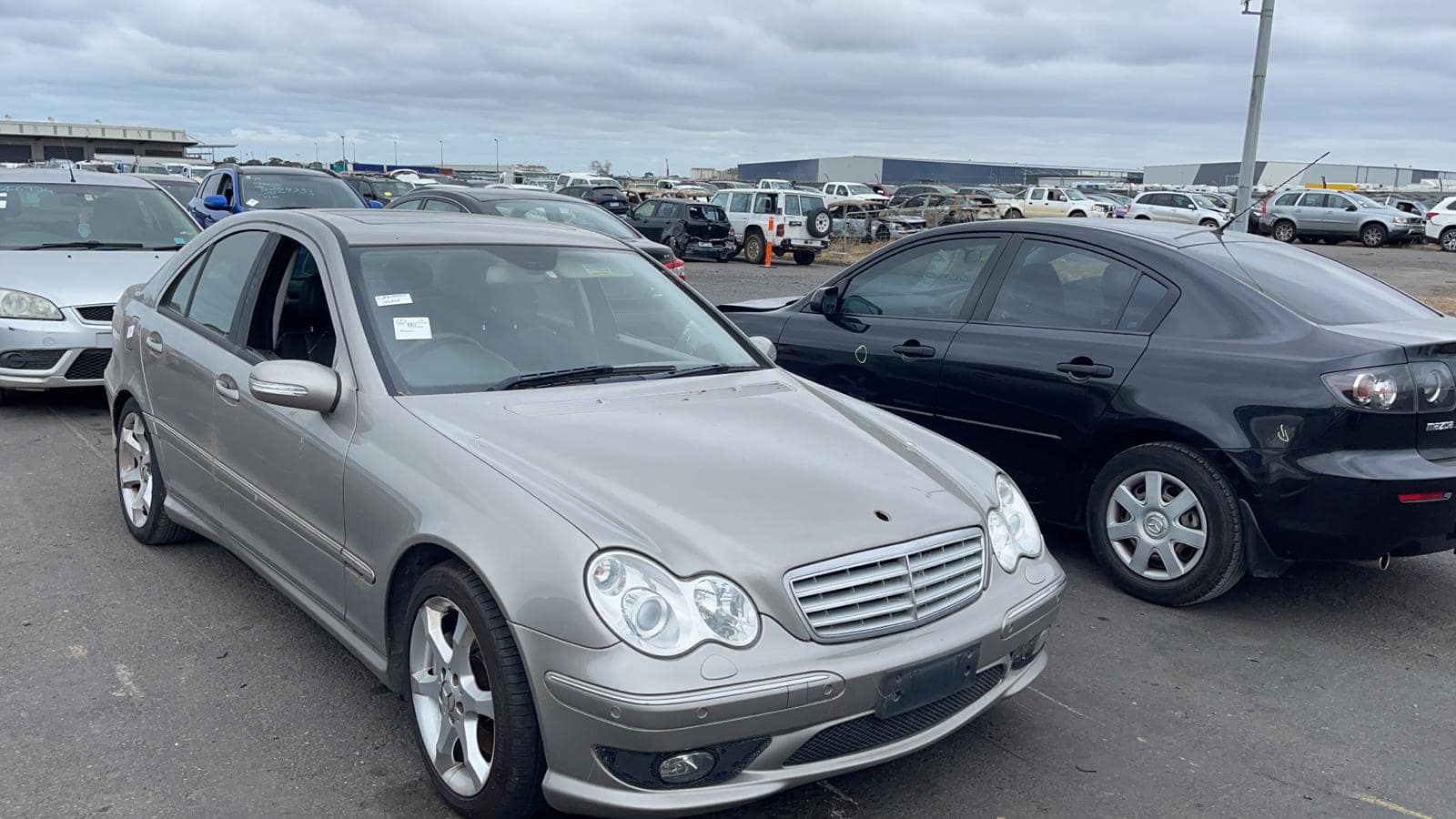 Silver sedan in a vehicle yard