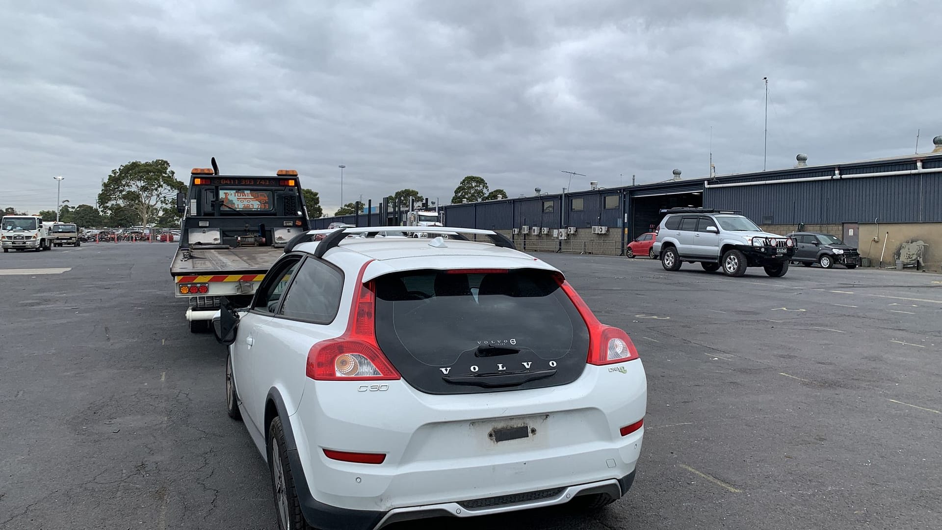 White hatchback photographed from the rear