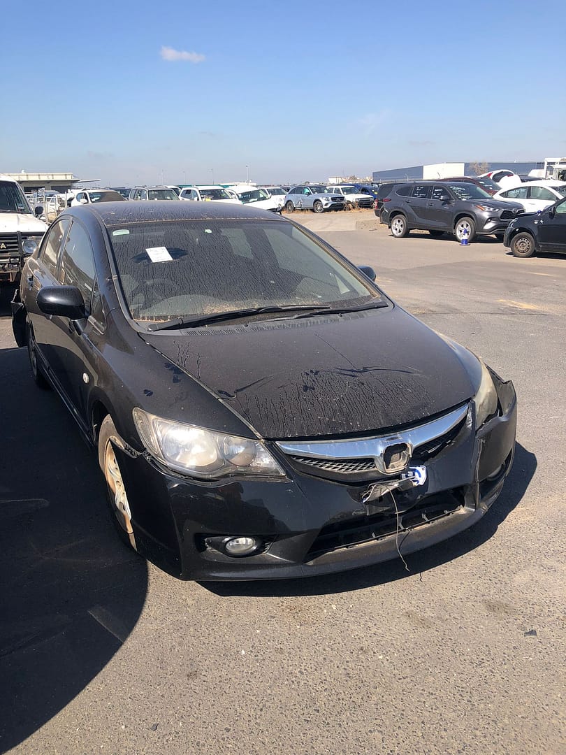 Dark sedan with front-end damage