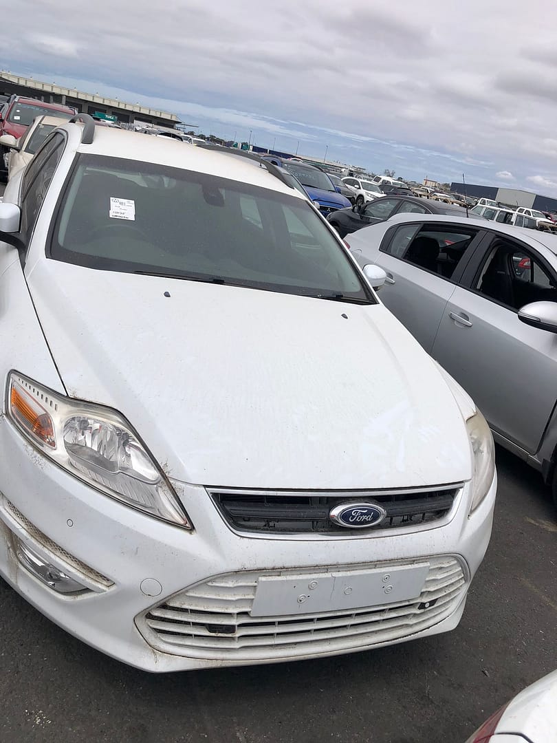White car parked in a vehicle yard