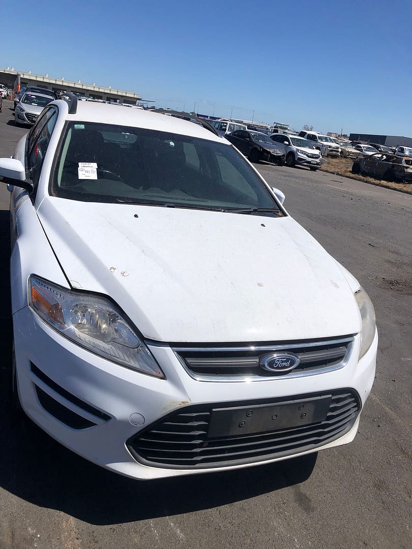 White sedan photographed from the front