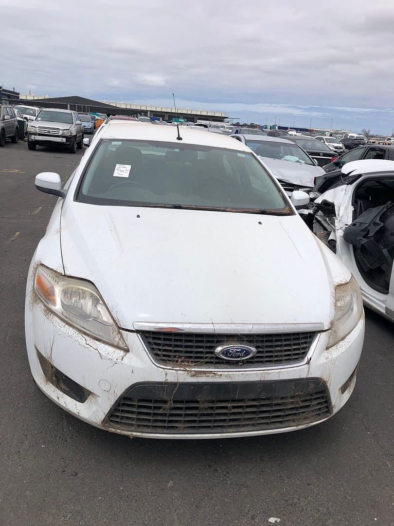 White sedan in a vehicle yard